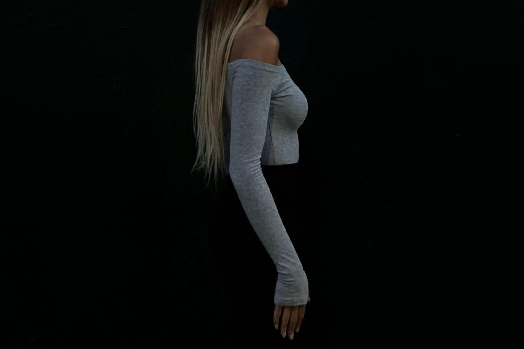 Side view of grey off the shoulder long sleeve top