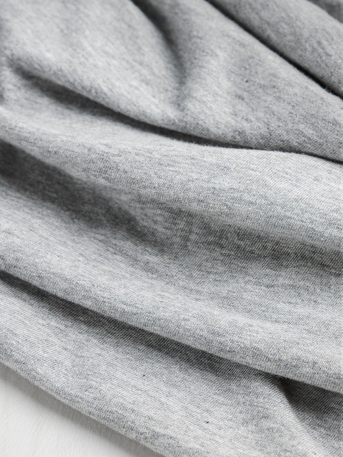up close materiel of the grey off the shoulder long sleeve top